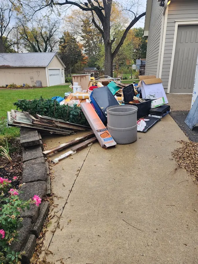 Dumpster being loaded with debris for Roofing Dumpster Rental in Hubbardston